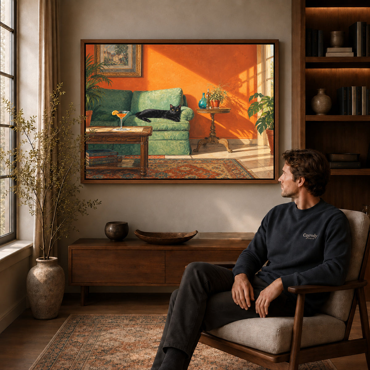 sunlit cat lounge canvas art in a walnut frame above a console beside a seated man.