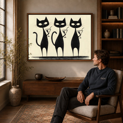 cocktail cat trio canvas art in a walnut frame above a console beside a seated man.