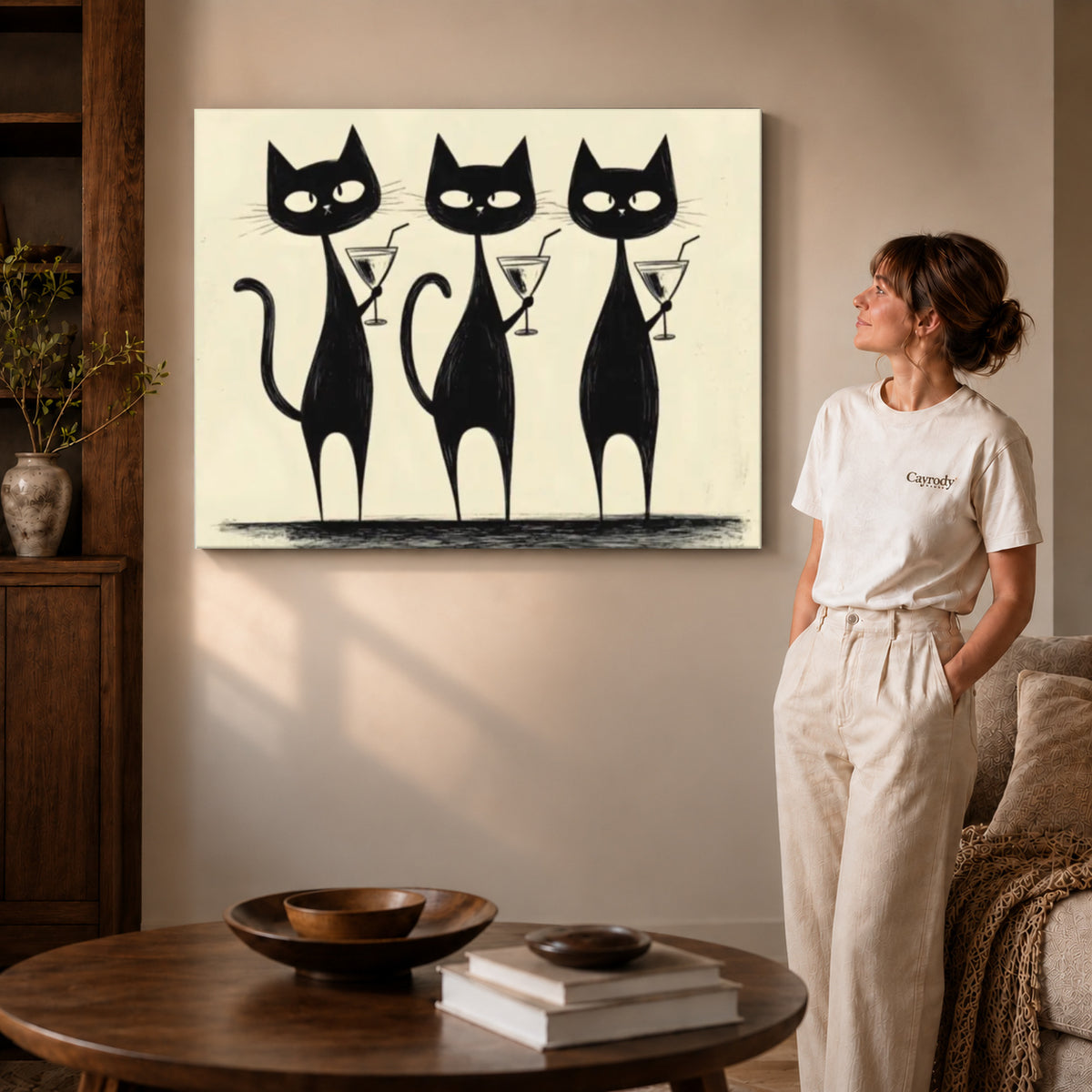cocktail cat trio canvas art on gallery-wrapped canvas with visible edge depth beside a standing woman.