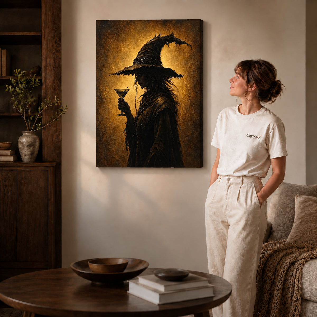 golden twilight witch canvas art on gallery-wrapped canvas with natural edge shading beside a standing woman.