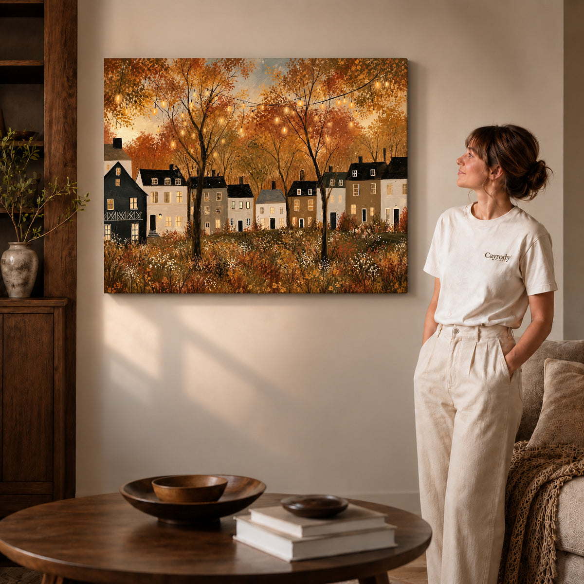 golden village lights canvas art on gallery-wrapped canvas with visible edge depth beside a standing woman.