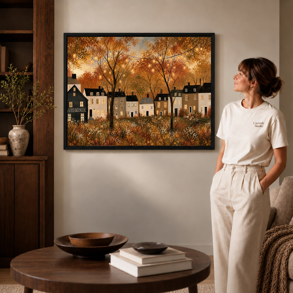 golden village lights canvas art shown in the black frame option against a softly lit wall.