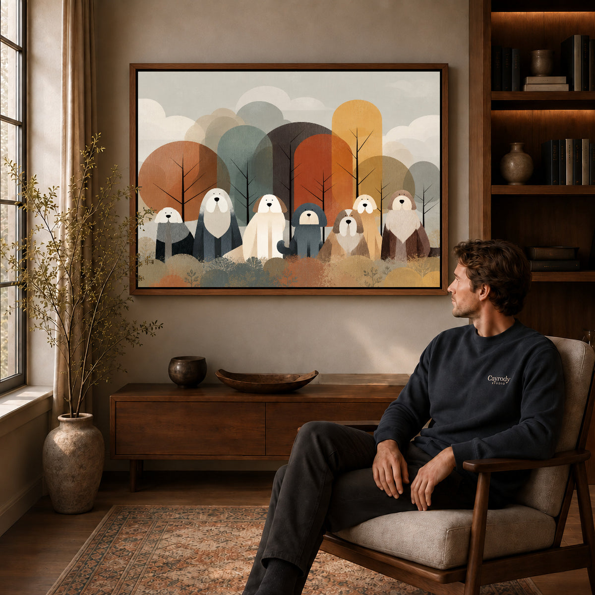 shaggy woodland companions canvas art in a walnut frame above a console beside a seated man.