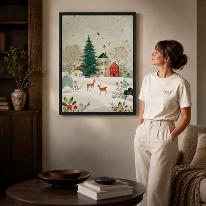 snowy village deer canvas art in a black frame beside a woman and round wooden table.