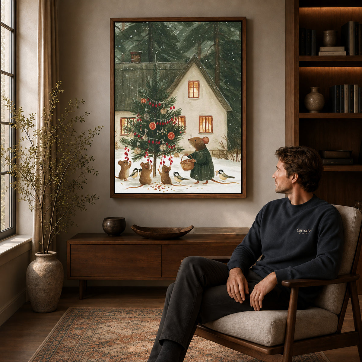 woodland christmas canvas art in a walnut frame above a console beside a seated man.