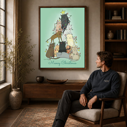 meowy christmas cats canvas art in a walnut frame above a console beside a seated man.