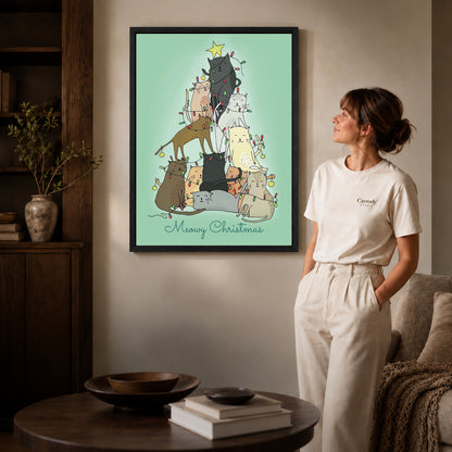 meowy christmas cats canvas art shown in the black frame option against a softly lit wall.