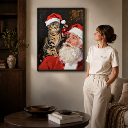santa cat surprise canvas art in a black frame beside a woman and round wooden table.