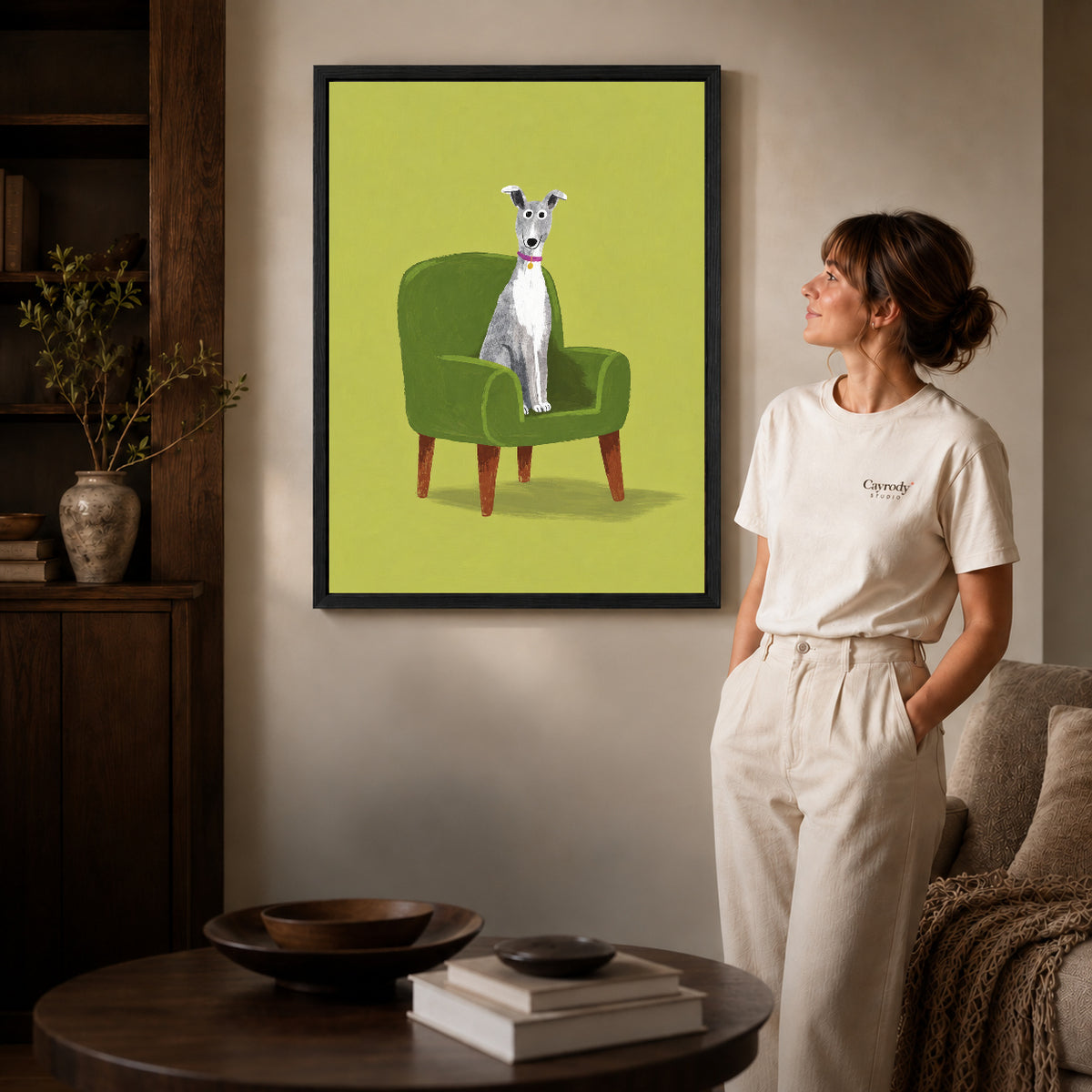whippet favorite chair canvas art shown in the black frame option against a softly lit wall.