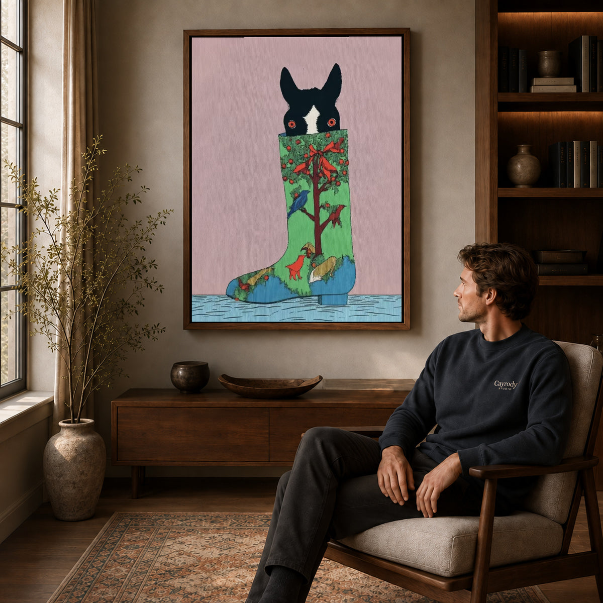 christmas stocking pup canvas art in a walnut frame above a console beside a seated man.