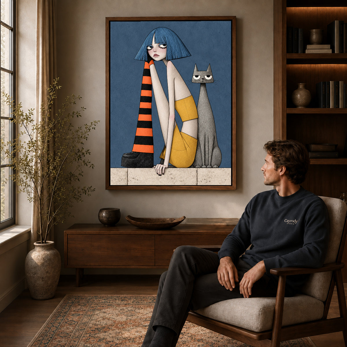 blue bob companions canvas art in a walnut frame above a console beside a seated man.