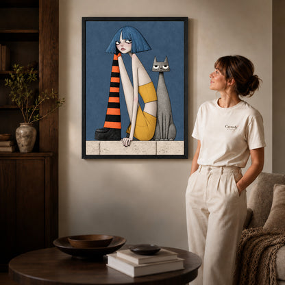 blue bob companions canvas art in a black frame beside a woman and round wooden table.