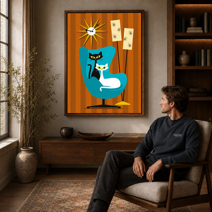 midcentury cat chair canvas art in a walnut frame above a console beside a seated man.