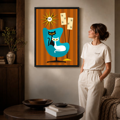 midcentury cat chair canvas art shown in the black frame option against a softly lit wall.