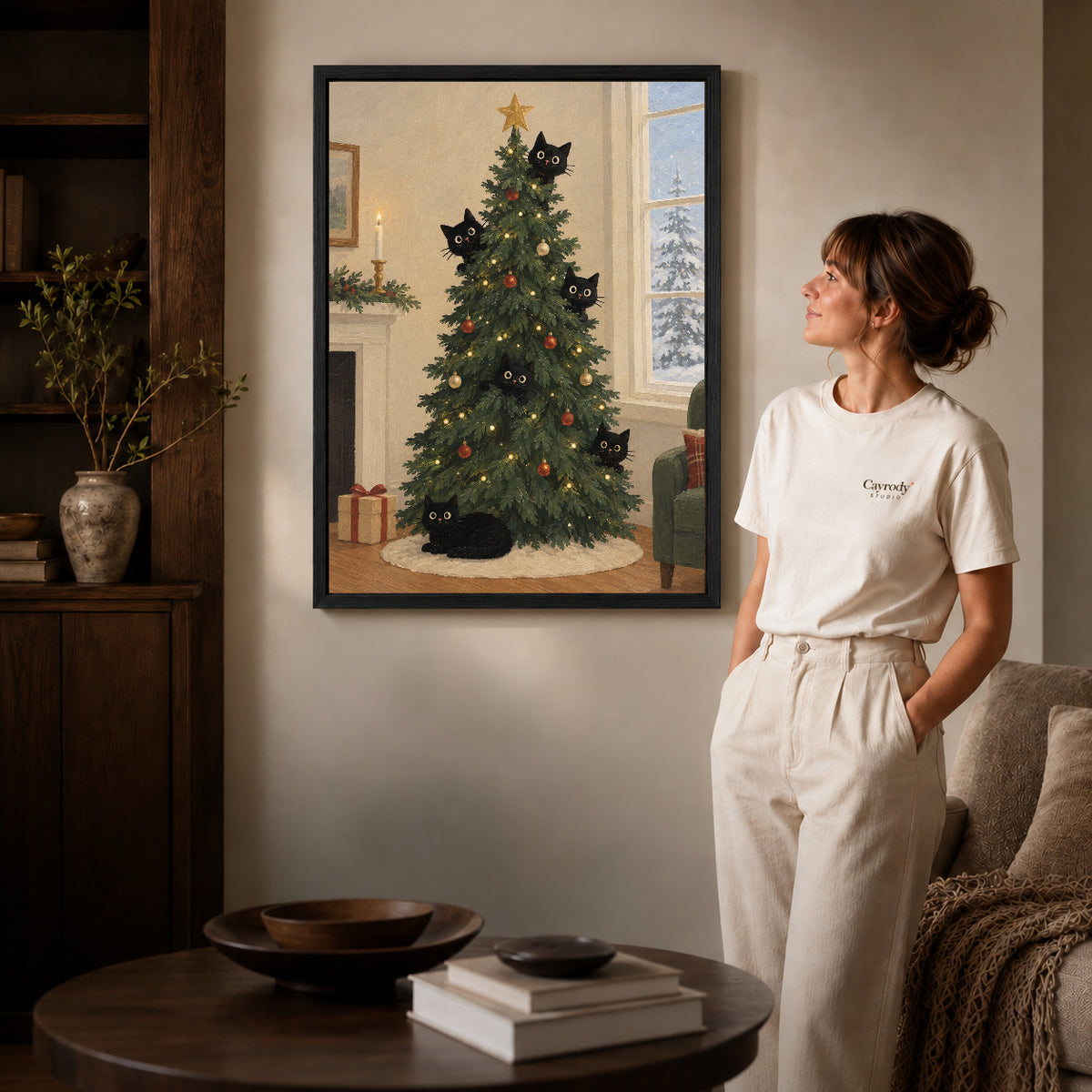 christmas tree cats canvas art shown in the black frame option against a softly lit wall.