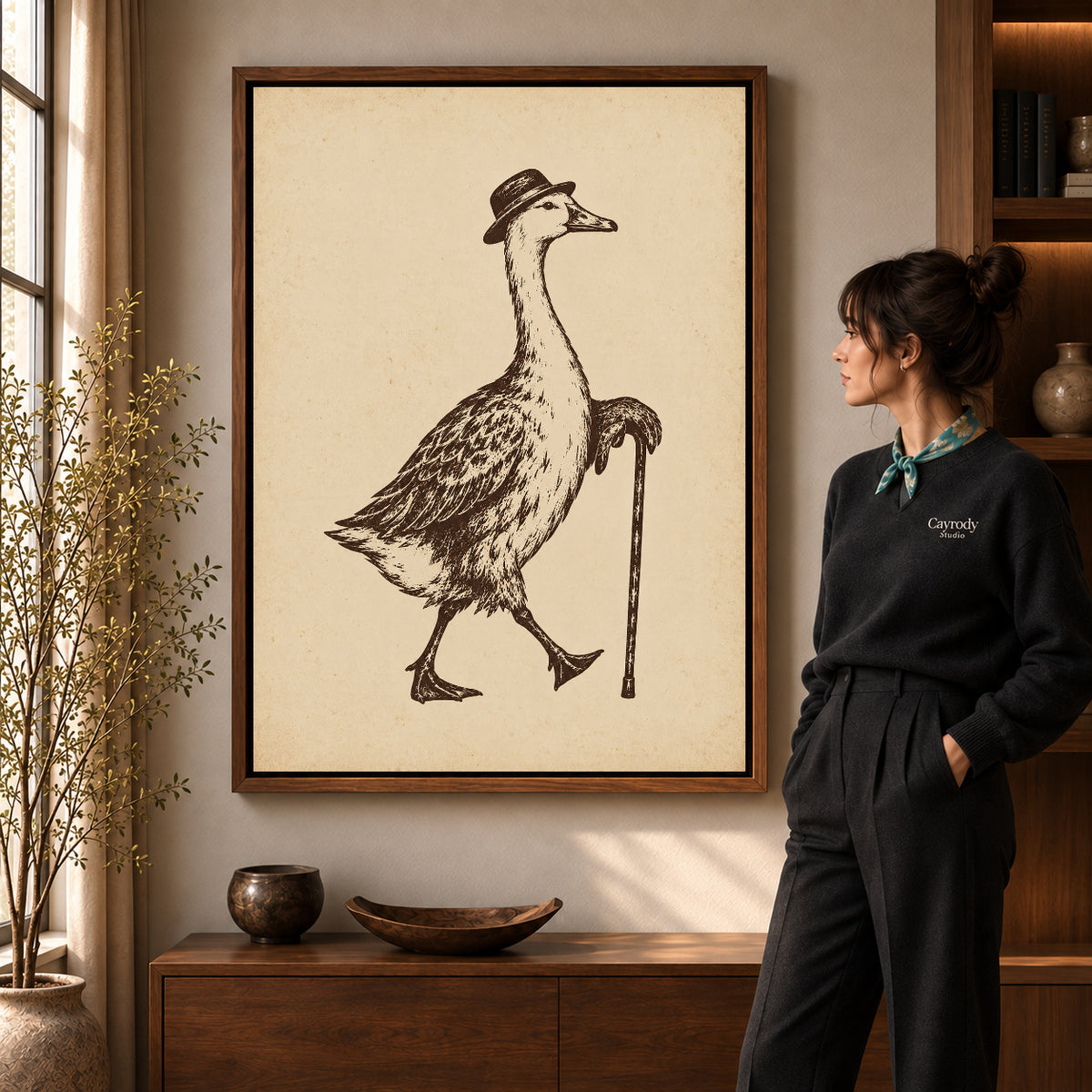 dapper goose stroll canvas art in a walnut frame beside a standing woman and wooden console.