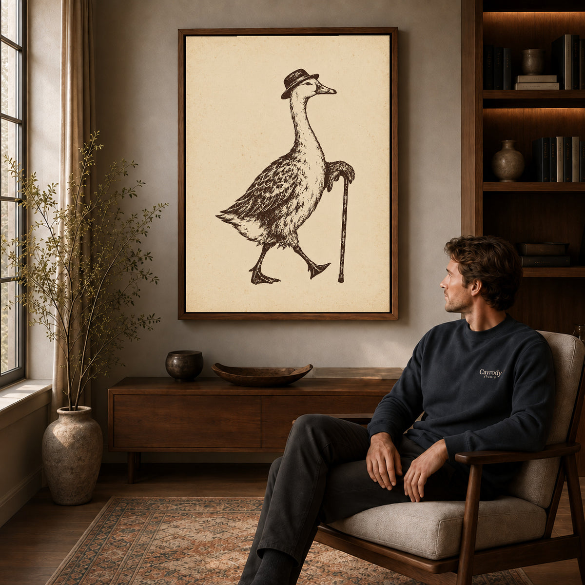 dapper goose stroll canvas art in a walnut frame above a console beside a seated man.