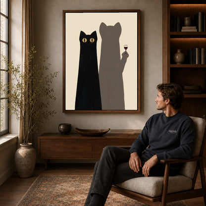 cat shadow toast canvas art in a walnut frame above a console beside a seated man.