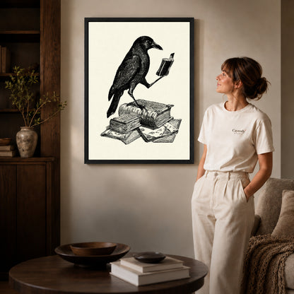 literary crow companion canvas art in a black frame beside a woman and round wooden table.
