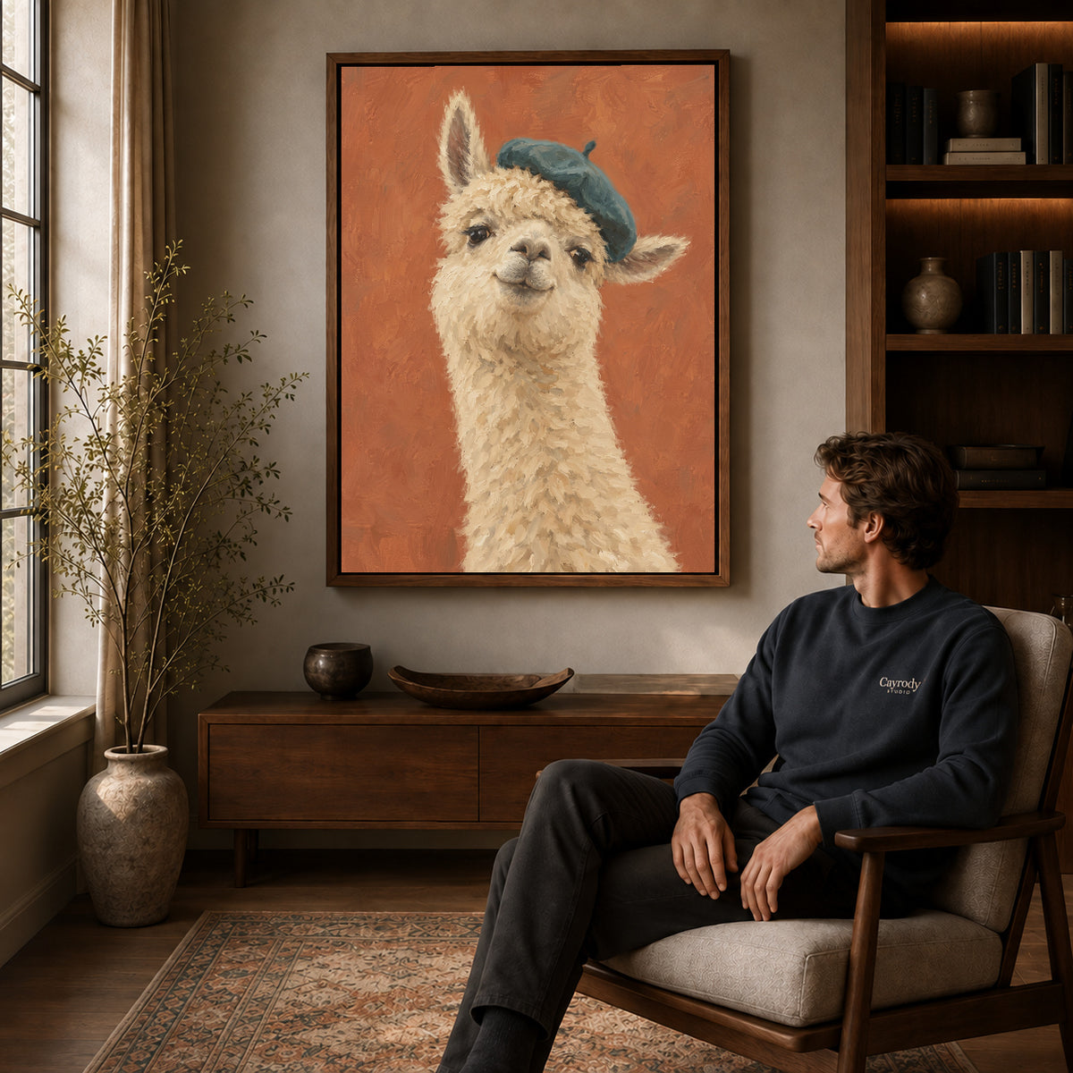 beret llama portrait canvas art in a walnut frame above a console beside a seated man.