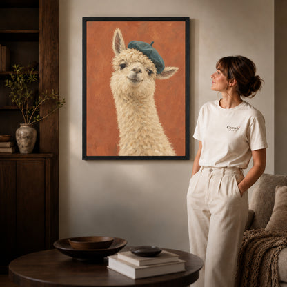 beret llama portrait canvas art in a black frame beside a woman and round wooden table.