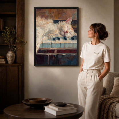 sleepy piano cat canvas art shown in the black frame option against a softly lit wall.