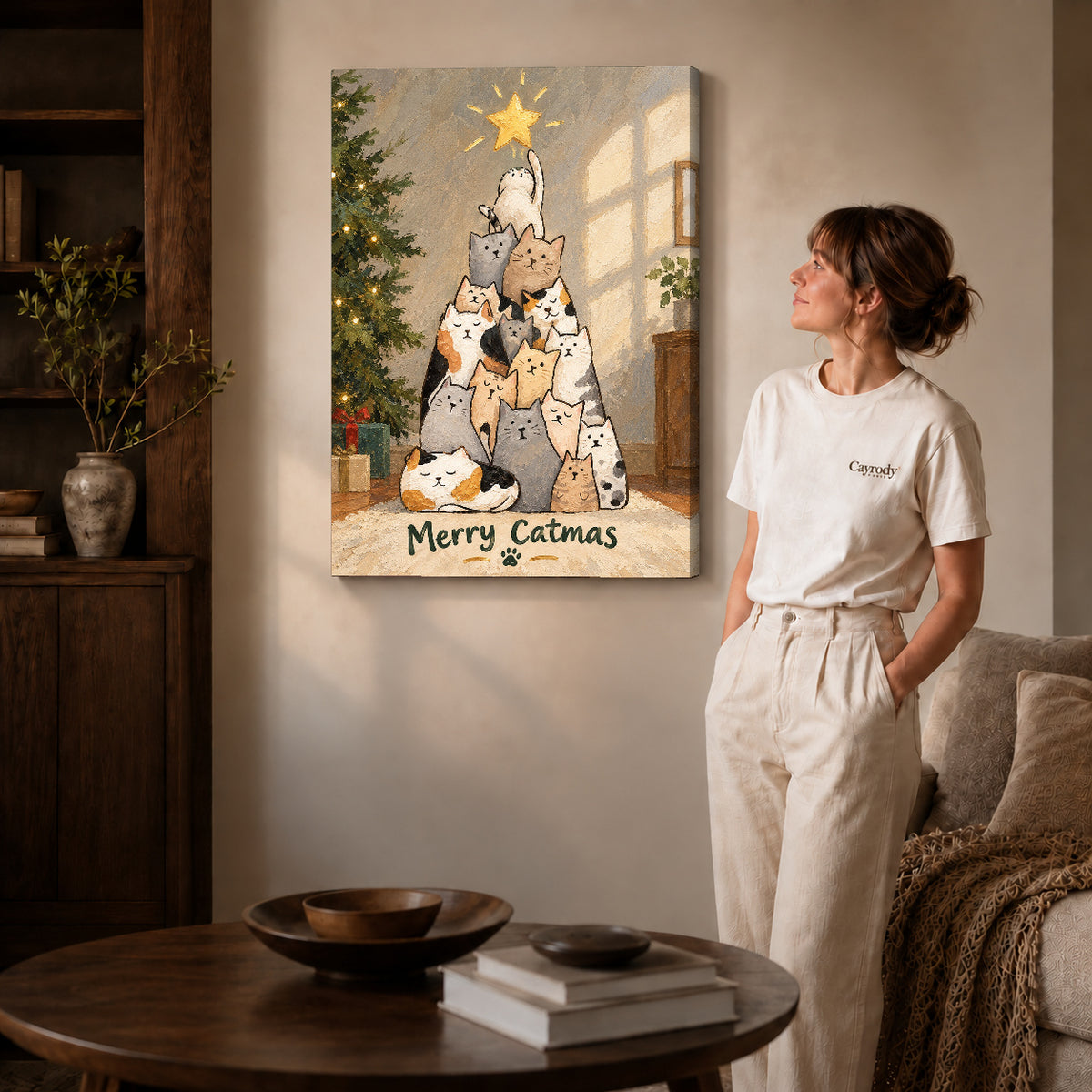 merry catmas gathering canvas art on gallery-wrapped canvas with natural edge shading beside a standing woman.