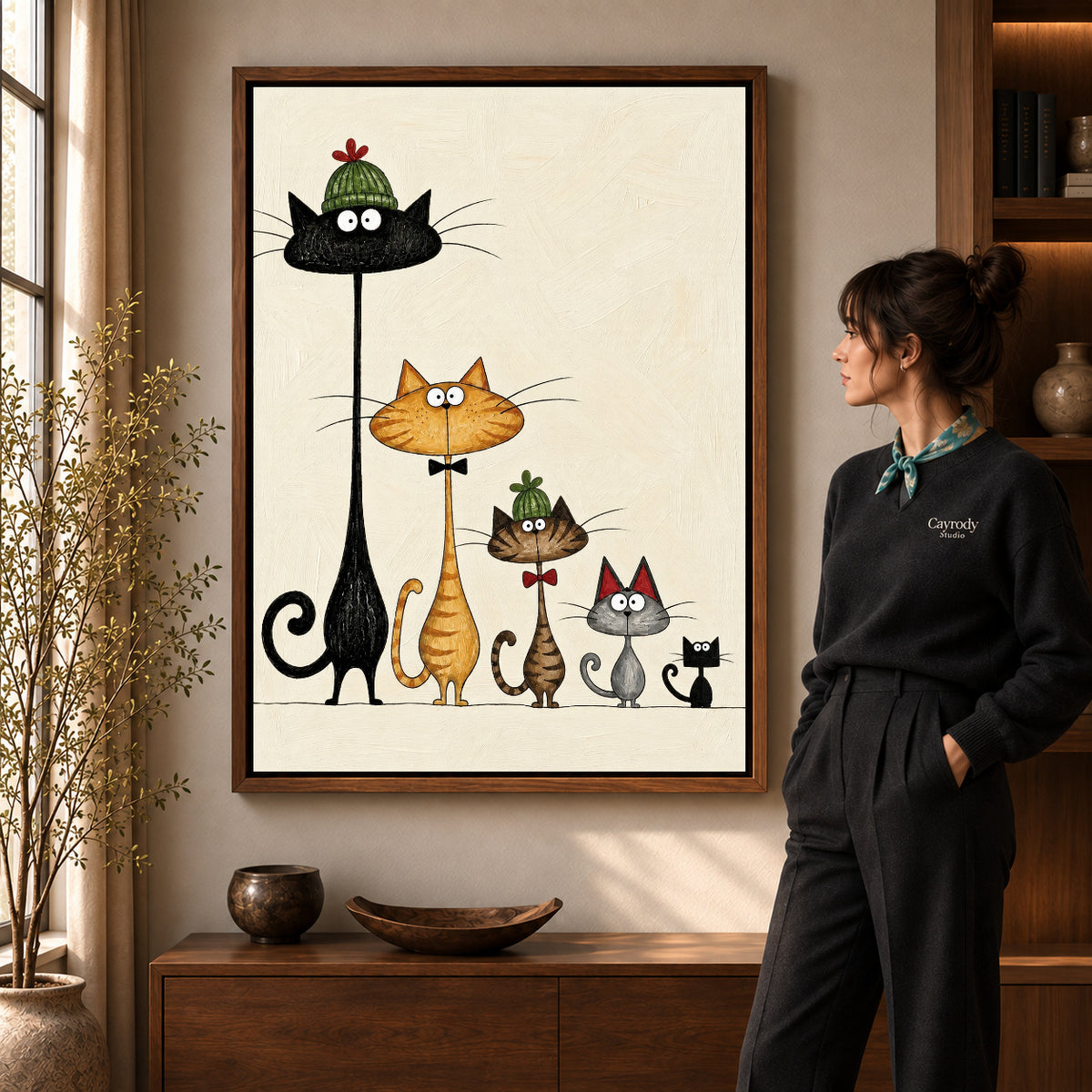 dressed cat gathering canvas art in a walnut frame beside a standing woman and wooden console.