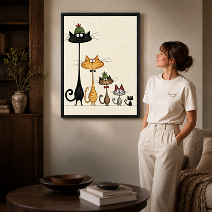 dressed cat gathering canvas art in a black frame beside a woman and round wooden table.