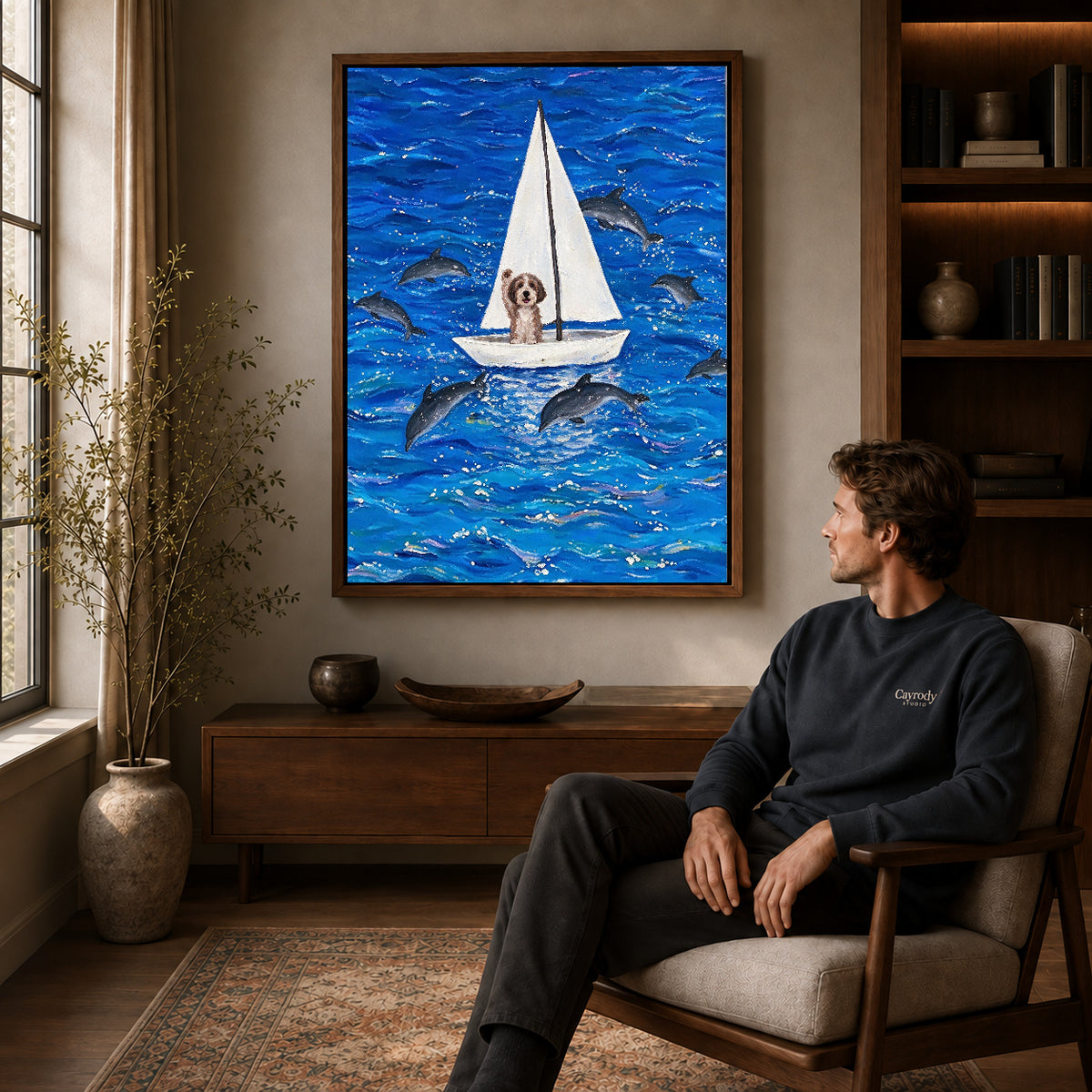seafaring dog adventure canvas art in a walnut frame above a console beside a seated man.