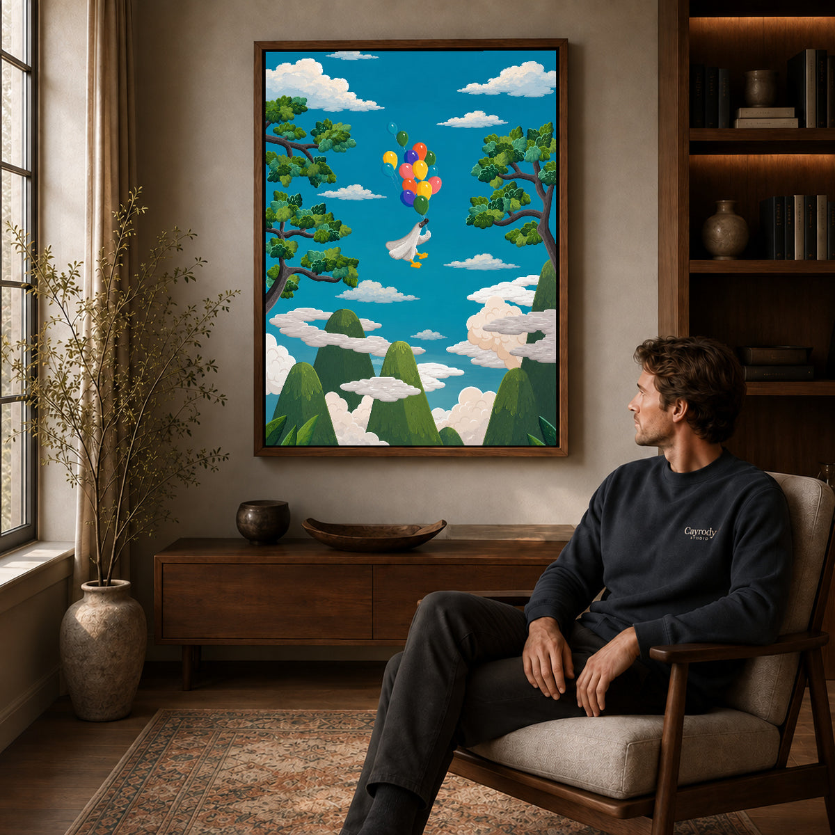 balloon goose journey canvas art in a walnut frame above a console beside a seated man.
