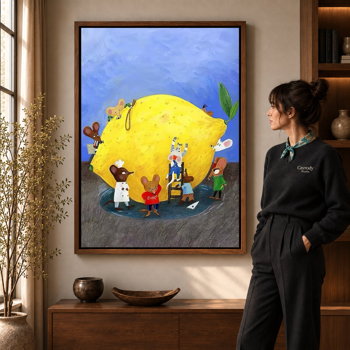 little lemon workshop canvas art in a walnut frame beside a standing woman and wooden console.