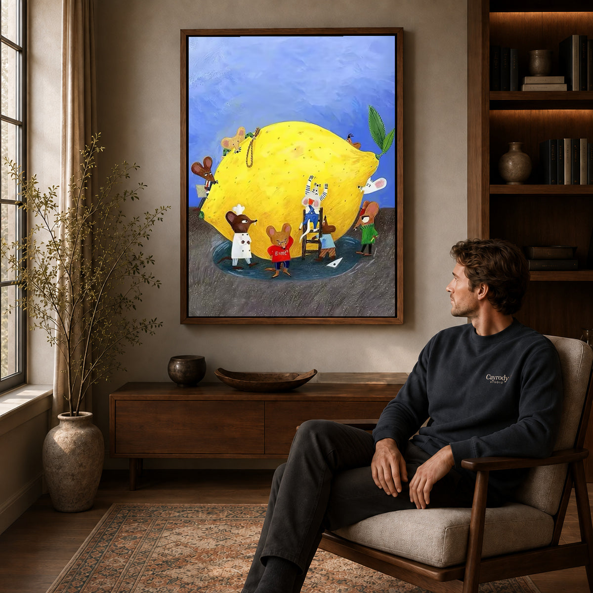 little lemon workshop canvas art in a walnut frame above a console beside a seated man.