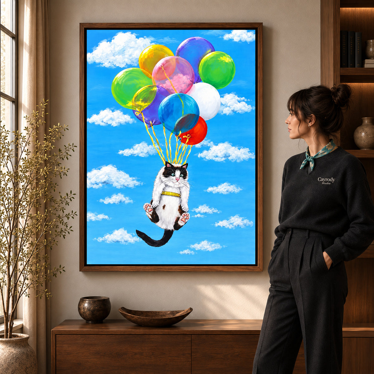 balloon cat adventure canvas art shown in the walnut frame option within a warm living room.
