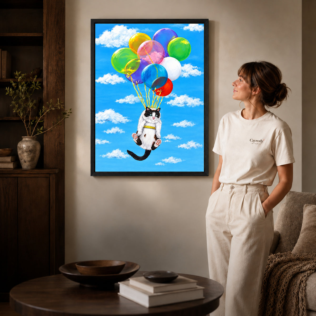 balloon cat adventure canvas art shown in the black frame option against a softly lit wall.