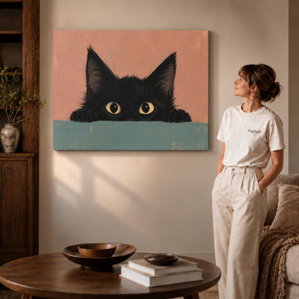 curious peeking kitten canvas art on gallery-wrapped canvas with visible edge depth beside a standing woman.