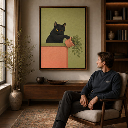 mischievous plant cat canvas art in a walnut frame above a console beside a seated man.