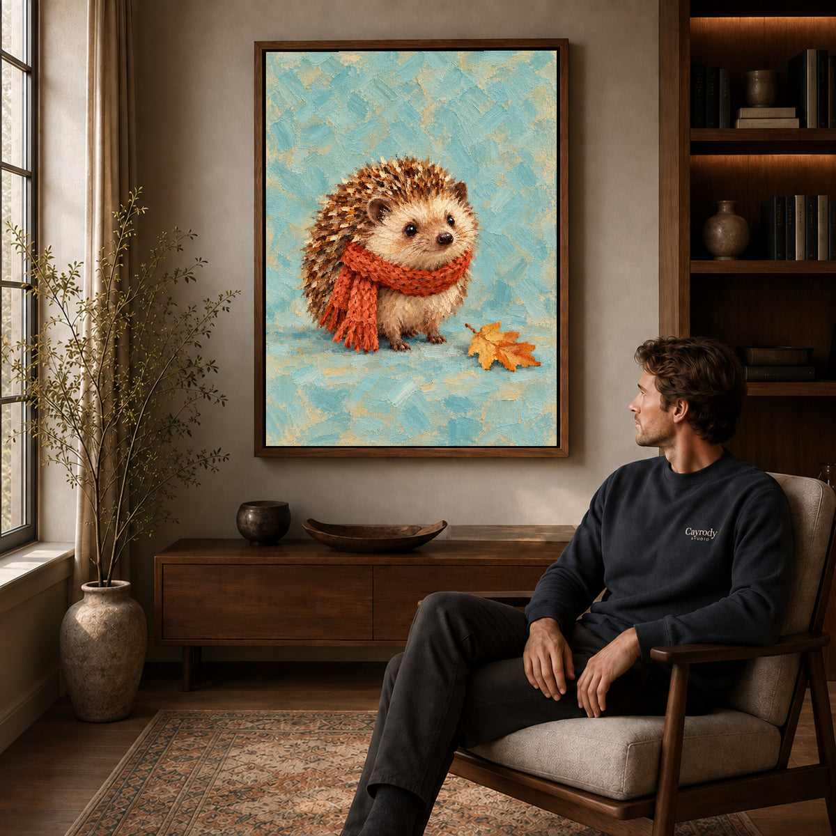 autumn scarf hedgehog canvas art in a walnut frame above a console beside a seated man.
