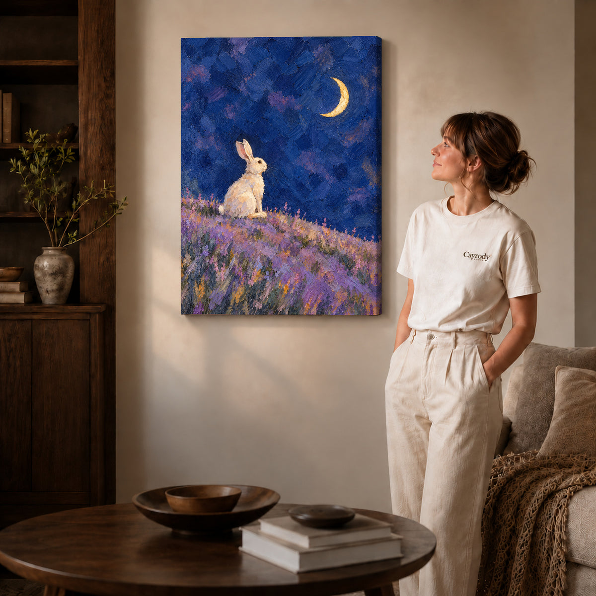 moonlit lavender rabbit canvas art on gallery-wrapped canvas with natural edge shading beside a standing woman.