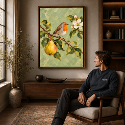 robin pear blossoms canvas art in a walnut frame above a console beside a seated man.