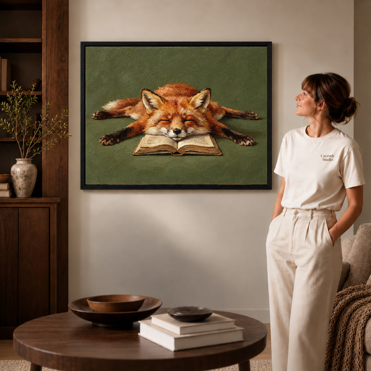 sleepy book fox canvas art shown in the black frame option against a softly lit wall.