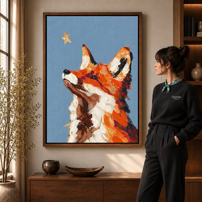 stargazing fox portrait canvas art in a walnut frame beside a standing woman and wooden console.