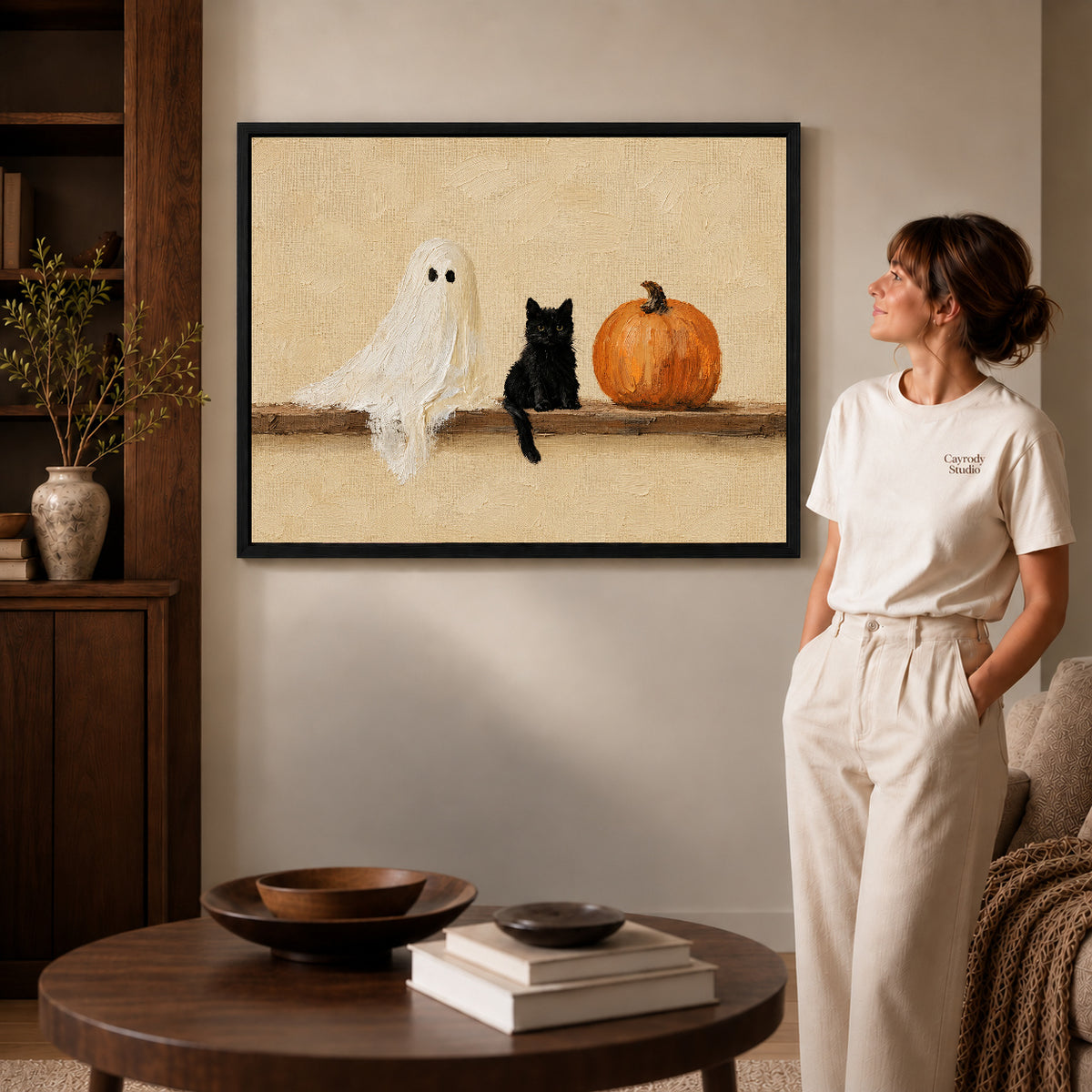 ghost kitten gathering canvas art shown in the black frame option against a softly lit wall.