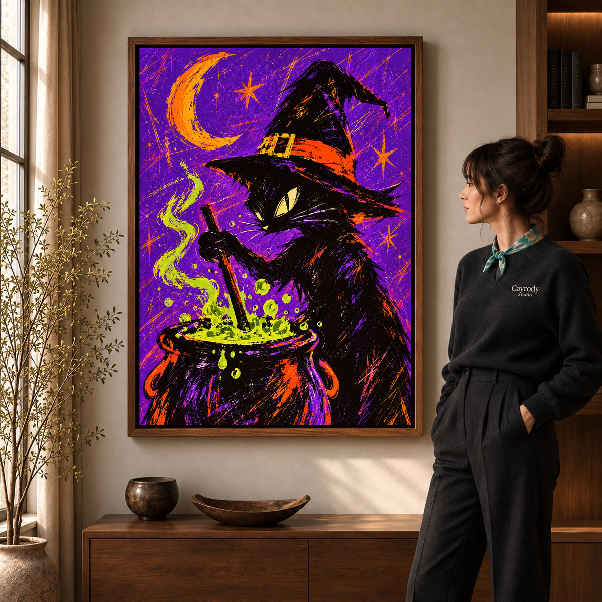 witch cat cauldron canvas art shown in the walnut frame option within a warm living room.