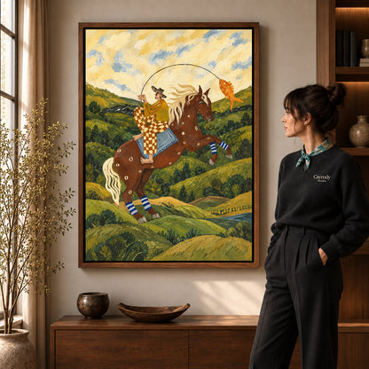 horseback fishing canvas art in a walnut frame beside a standing woman and wooden console.