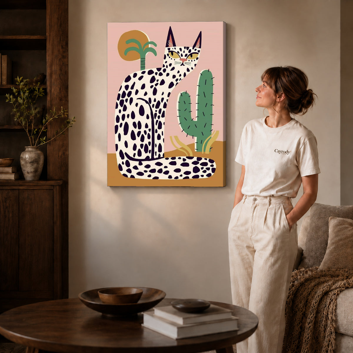 spotted desert cat canvas art on gallery-wrapped canvas with natural edge shading beside a standing woman.