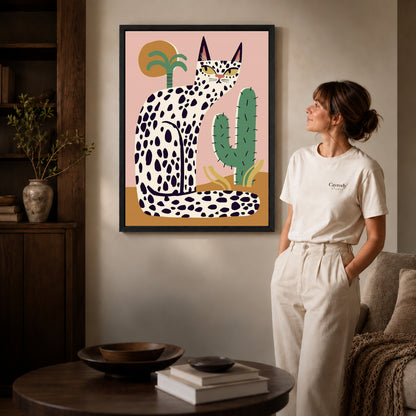 spotted desert cat canvas art shown in the black frame option against a softly lit wall.