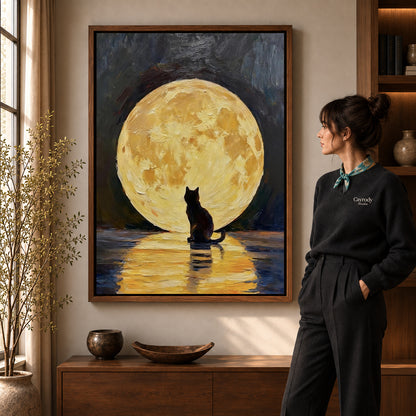 golden moon cat canvas art in a walnut frame beside a standing woman and wooden console.