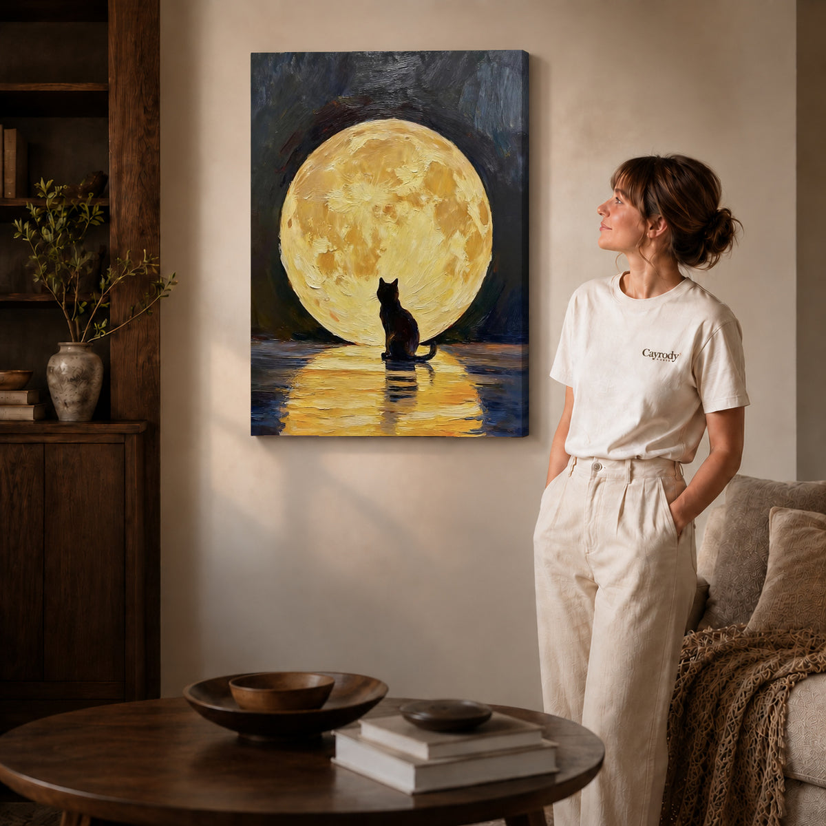 golden moon cat canvas art on gallery-wrapped canvas with natural edge shading beside a standing woman.