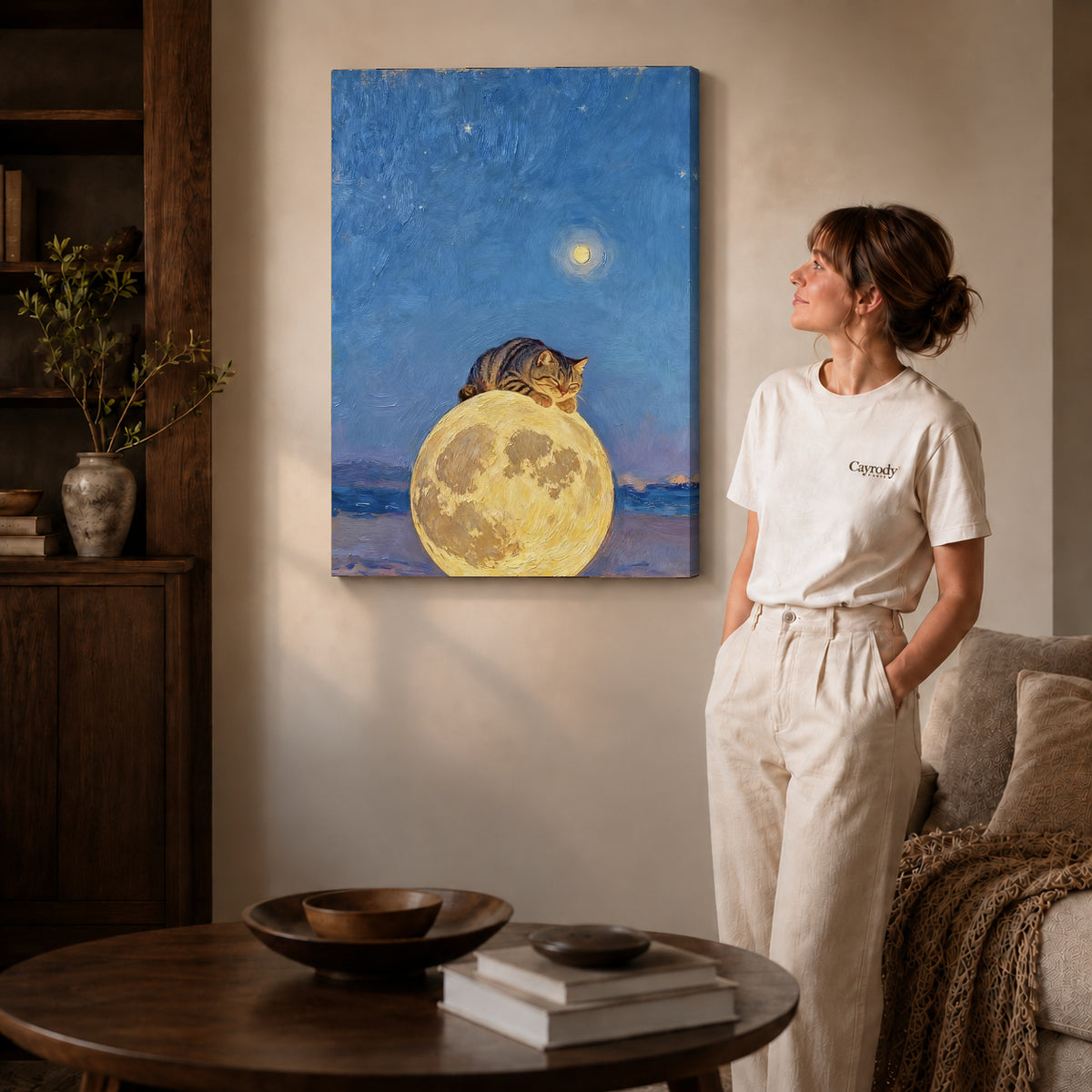 moon pillow cat canvas art on gallery-wrapped canvas with natural edge shading beside a standing woman.